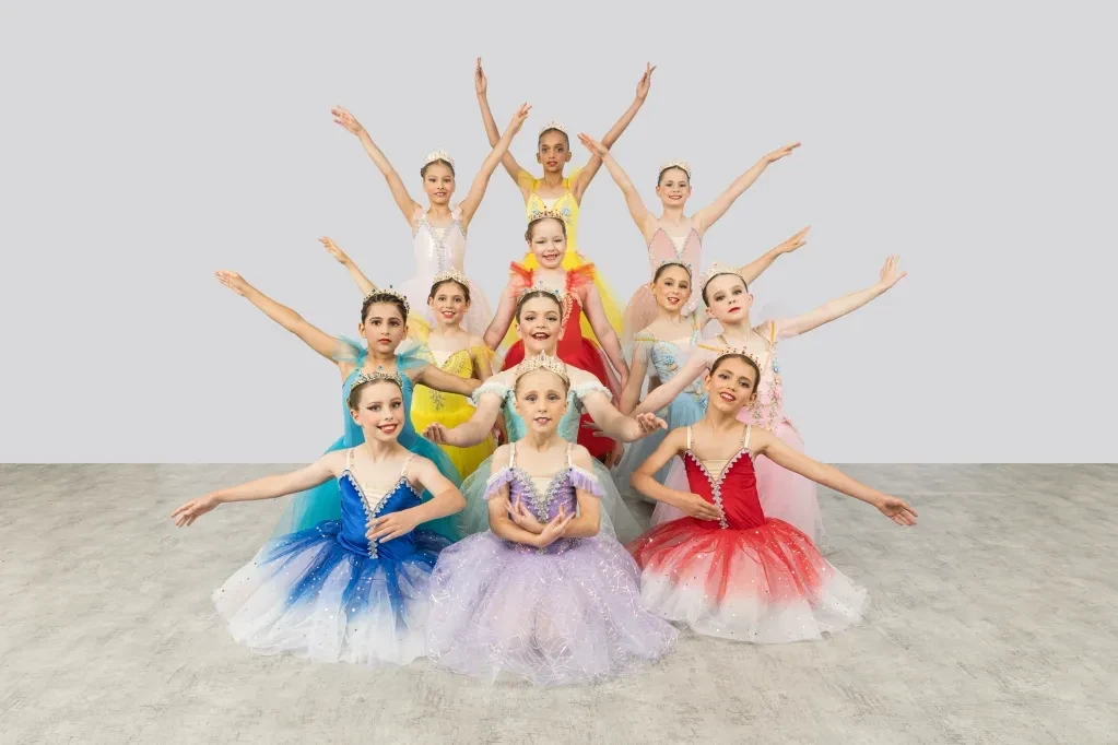 Young ballet dancers in colourful tutus posing