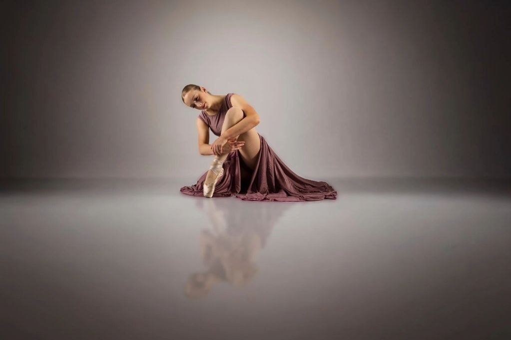 Ballet dancer seated on floor