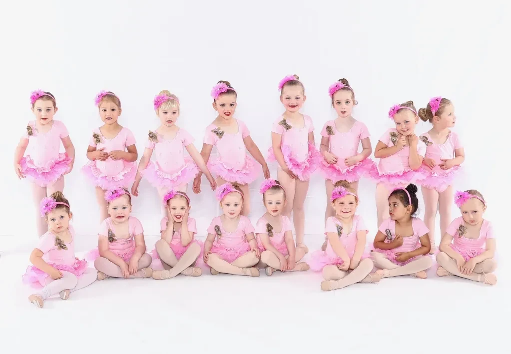 Large group of tiny dancers in pink tutus and floral headbands