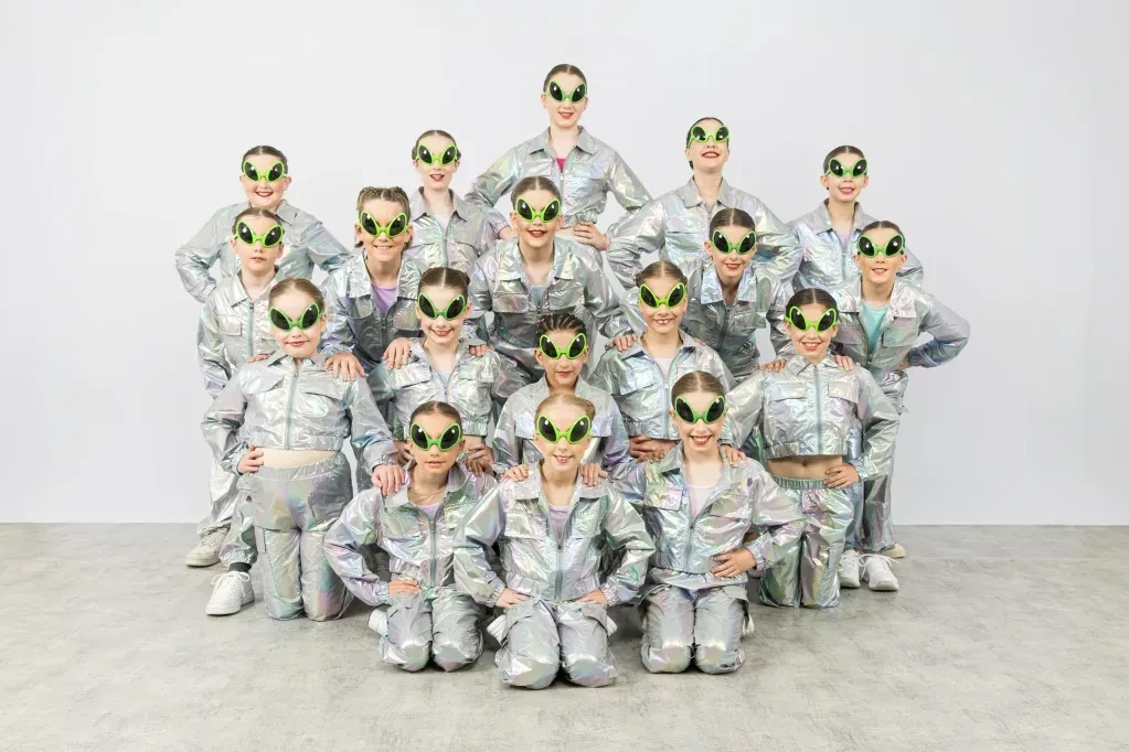 Group in silver alien spacesuits and glasses